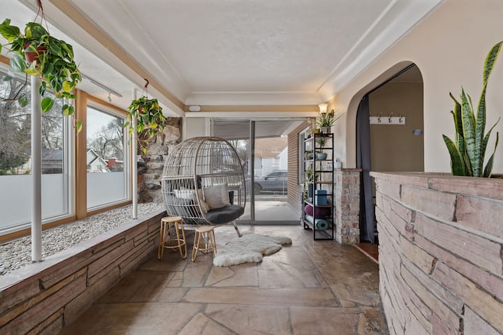 Garden Haus sunroom with hanging chair and plants